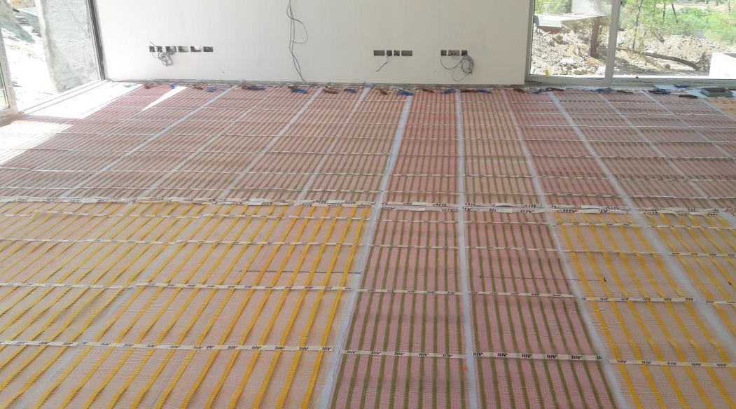 Heat mats installed across a room